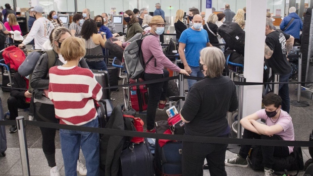 Travellers wait in line at a check-in desk at Trudeau Airport in Montreal, Wednesday, April 20, 2022. Canadian airports and airlines yielded a large number of flight delays last month, raising questions about their readiness for the summer travel rush. THE CANADIAN PRESS/Graham Hughes