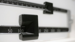 FILE- A closeup of a beam scale is seen in New York on April 3, 2018. Tirzepatide, a drug from Eli Lilly and Co. approved to treat type 2 diabetes under the brand name Mounjaro, helped people with the disease who were overweight or had obesity lose up to 16% of their body weight, or more than 34 pounds, over nearly 17 months, the company said on Thursday, April 27, 2023. (AP Photo/Patrick Sison, File)