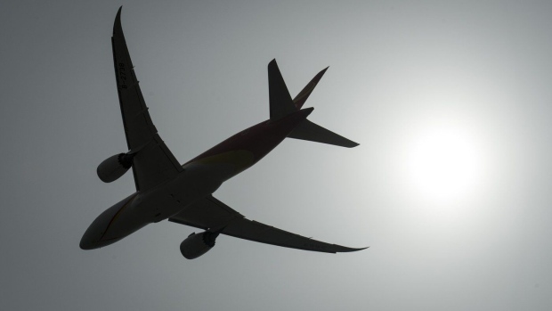 A plane is silhouetted as it takes off from Vancouver International Airport in Richmond, B.C., Monday, May 13, 2019. Pilots are speaking out against an aviation industry push toward a sole crew member in the cockpit. THE CANADIAN PRESS/Jonathan Hayward