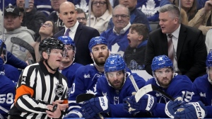 Referee Trevor Hanson (14) has a word with Toronto Maple Leafs head coach Sheldon Keefe, right, after a call against Leafs' Mark Giordano, not shown, during first period, second round, game one, NHL Stanley Cup hockey action against the Florida Panthers, in Toronto, Tuesday, May 2, 2023. With Toronto staring at an 0-2 deficit going on the road for the next two games, Keefe said his team isn't lacking confidence in making it a series when the teams meet for Game 3 on Sunday. THE CANADIAN PRESS/Frank Gunn