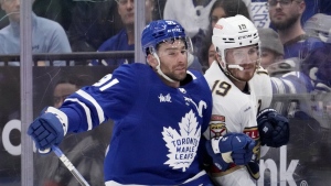 Toronto Maple Leafs centre John Tavares (91) checks Florida Panthers left wing Matthew Tkachuk (19) during first period, second round, game one, NHL Stanley Cup hockey action in Toronto, Tuesday, May 2, 2023. THE CANADIAN PRESS/Frank Gunn