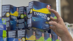 Tammy Compton restocks tampons at Compton's Market, in Sacramento, Calif., June 22, 2016. Federally regulated workplaces will begin offering free menstrual products to workers starting on December 15. THE CANADIAN PRESS/AP-Rich Pedroncelli
