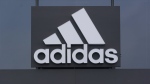 FILE - A sign is displayed in front of an Adidas retail store in Paramus, N.J., Oct. 25, 2022. After months wrestling over the fate of millions of unsold Yeezy shoes, Adidas has decided to sell a portion of its remaining inventory and donate the proceeds to charitable organizations, CEO of the German sport brand Bjørn Gulden said Thursday, May 11, 2023. (AP Photo/Seth Wenig, File)