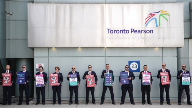 WestJet Airlines pilots stand on a picket line at Toronto's Pearson Airport on Monday May 8, 2023. The travel plans of WestJet customers are up in the air after its pilots' union issued a 72-hour strike notice last night. THE CANADIAN PRESS/Chris Young