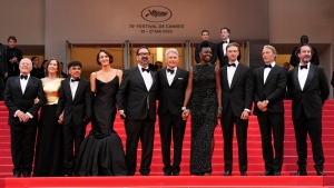 Producer Frank Marshall, from left, producer Kathleen Kennedy, Ethann Isidore, Phoebe Waller-Bridge, director James Mangold, Harrison Ford, Shaunette Renee Wilson, Boyd Holbrook, Mads Mikkelsen and producer Simon Emanuel pose for photographers upon arrival at the premiere of the film 'Indiana Jones and the Dial of Destiny' at the 76th international film festival, Cannes, southern France, Thursday, May 18, 2023. (Photo by Scott Garfitt/Invision/AP)