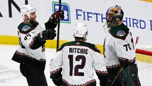 Arizona Coyotes goaltender Karel Vejmelka (70) is congratulated by right wing Zack Kassian (44) and left wing Nick Ritchie (12) after their win over the Nashville Predators in an NHL hockey game Monday, Feb. 13, 2023, in Nashville, Tenn. (AP Photo/Mark Zaleski)