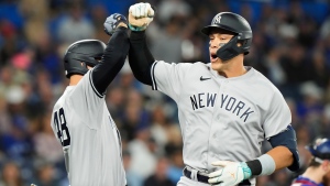 New York Yankees designated hitter Aaron Judge (99) celebrates his two-run home run against the Toronto Blue Jays with teammate Anthony Rizzo (48) during first inning MLB American League baseball action in Toronto, on Thursday, May 18, 2023. THE CANADIAN PRESS/Frank Gunn
