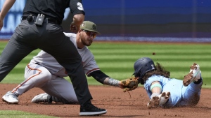 Baltimore Orioles shortstop Joey Ortiz (65) tags out Toronto Blue Jays Bo Bichette on a steal attempt of second base during first inning American League baseball action in Toronto on Sunday, May 21, 2023. THE CANADIAN PRESS/Frank Gunn