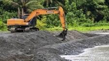 excavator Laelae River shoreline Guam