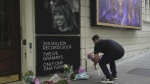 A man places flowers outside the Aldwych Theatre in London, Thursday, May 25, 2023. London's Aldwych Theatre is housing the Tina Turner musical where fans put down tribute to the unstoppable singer and stage performer who died Wednesday, after a long illness at her home in Kuesnacht near Zurich, Switzerland, according to her manager. She was 83. THE CANADIAN PRESS/AP, Kin Cheung