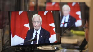 David Johnston, Independent Special Rapporteur on Foreign Interference, is pictured on the screens of translators as he presents his first report in Ottawa on Tuesday, May 23, 2023. THE CANADIAN PRESS/Sean Kilpatrick