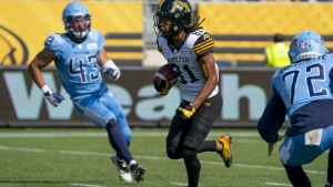 Hamilton Tiger Cats wide receiver Lio'undre Gallimore (81) runs on his way to a long return for a touchdown against the Toronto Argonauts during first half CFL pre-season football action in Hamilton on Saturday, May 27, 2023. THE CANADIAN PRESS/Peter Power