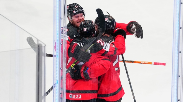 Canada's Scott Laughton celebrates with teammates after his empty net goal during the gold medal match against Germany at the Ice Hockey World Championship in Tampere, Finland, Sunday, May 28, 2023. (AP Photo/Pavel Golovkin)