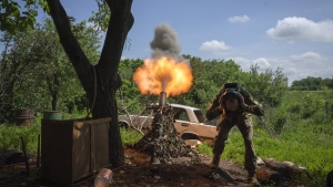 A Ukrainian soldier fires a mortar at Russian positions on the frontline near Bakhmut, Donetsk region, Ukraine, Monday, May 29, 2023. (AP Photo/Efrem Lukatsky)