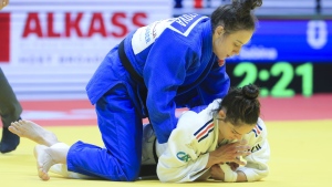 Sabina Giliazova of Russia and Blandine Pont of France, bottom, in action during the women's -48 category at the World Judo Championships in Doha, Qatar, Sunday, April 5, 2023. (AP Photo/Hussein Sayed)