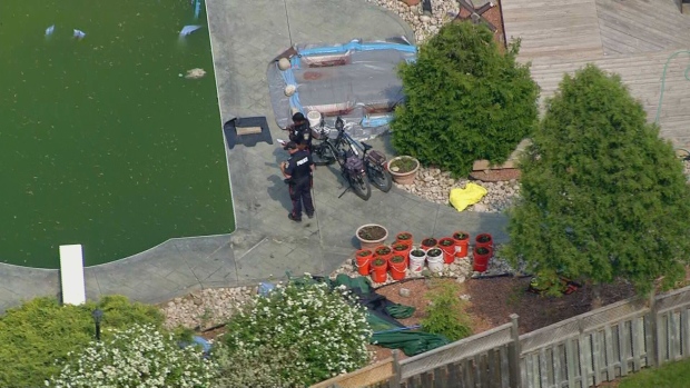 Police are shown investigating at the scene of a possible drowning in Brampton.