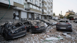 FILE - Damaged cars are parked in the yard of a multi-story apartment building which was damaged in a relentless wave of bombardments targeting in Kyiv, Ukraine, Tuesday, May 30, 2023. (AP Photo/Alex Babenko)