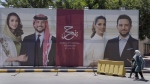 A poster with pictures of Crown Prince Hussein and his fiancee, Saudi architect Rajwa Alseif is posted at a road in Amman, Jordan, Wednesday, May 31, 2023. Crown Prince Hussein and Saudi architect Rajwa Alseif are to be married on Thursday at a palace wedding in Jordan, a Western-allied monarchy that has been a bastion of stability for decades as Middle East turmoil has lapped at its borders.(AP Photo/Nasser Nasser)

