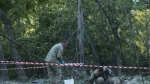 Police officers inspect the site of a Russian strike in Kyiv Ukraine, Thursday, June 1, 2023. (AP Photo/Wladyslaw Musiienko)
