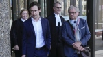 Australian journalists Nick McKenzie, second left, and Chris Masters, right, walk with their legal team from the Federal Court in Sydney, Australia, Thursday, June 1, 2023. Australia’s most decorated living war veteran unlawfully killed prisoners and committed other war crimes in Afghanistan, a judge ruled Thursday in dismissing the claims by Victoria Cross recipient Ben Roberts-Smith that he was defamed by media. (AP Photo/Mark Baker)