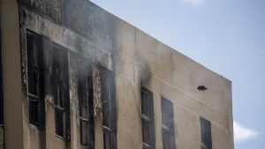 FILE - A drone inspects the damage following a fire near a hostel in central Wellington, New Zealand, on May 16, 2023. New Zealand police on Thursday, June 1, 2023 filed five murder charges against the man they say lit a deadly fire at a Wellington hostel two weeks ago. (Mark Mitchell/NZ Herald via AP, File)
