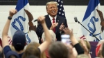 Former President Donald Trump reacts as he visits with campaign volunteers at the Grimes Community Complex Park, Thursday, June 1, 2023, in Des Moines, Iowa. (AP Photo/Charlie Neibergall)