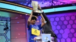 Dev Shah, 14, from Largo, Fla., lifts the trophy next to Scripps CEO Adam Symson after he won the Scripps National Spelling Bee finals, Thursday, June 1, 2023, in Oxon Hill, Md. (AP Photo/Nick Wass)