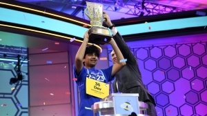Dev Shah, 14, from Largo, Fla., lifts the trophy next to Scripps CEO Adam Symson after he won the Scripps National Spelling Bee finals, Thursday, June 1, 2023, in Oxon Hill, Md. (AP Photo/Nick Wass)