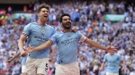 Manchester City's Ilkay Gundogan, right, celebrates after scoring his side's second goal during the English FA Cup final soccer match between Manchester City and Manchester United at Wembley Stadium in London, Saturday, June 3, 2023. (AP Photo/Dave Thompson)