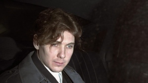Paul Bernardo sits in the back of a police cruiser as he leaves a hearing in St. Catharines, Ont., April 5, 1994. The lawyer for the families of Paul Bernardo's victims says the killer and serial rapist should be returned to his maximum-security prison and transparency be provided around what led to his transfer to a medium-security facility in the first place.THE CANADIAN PRESS/Frank Gunn