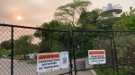 Signs advise people about ongoing construction on fences separating Trillium Park from the West island of Ontario Place Sunday June 4, 2023. (Joshua Freeman /CP24)