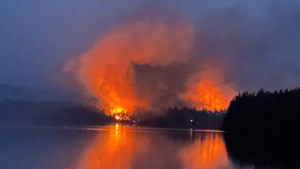 A wildfire burns near to Centennial Lake, near Matawatchan, Ont., on Sunday, June 4, 2023. The wildfire burning around Centennial Lake, about 150 kilometres west of Ottawa, was one of the 21 new fire starts in Ontario since Sunday, said fire adviser Shayne McCool, with the Ministry of Natural Resources and Forestry. THE CANADIAN PRESS/HO-Mike Coates