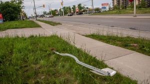 A destroyed street sign at the location where a family of five was hit by a driver, in London, Ont., Monday, June 7, 2021. Members of the Muslim community in London will host a vigil to mark the second anniversary of the worst mass killing in the city's history. THE CANADIAN PRESS/Brett Gundlock
