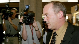 Homicide detective Michael Campeau prepares to hold a press conference to discusses the arrest of Michael White at police headquarters in Edmonton, Tuesday, July 19, 2005. The Parole Board of Canada says Michael White, convicted of killing his pregnant wife and dumping her body in a ditch 17 years ago, was granted full parole following a review of his case. THE CANADIAN PRESS/Jason Scott