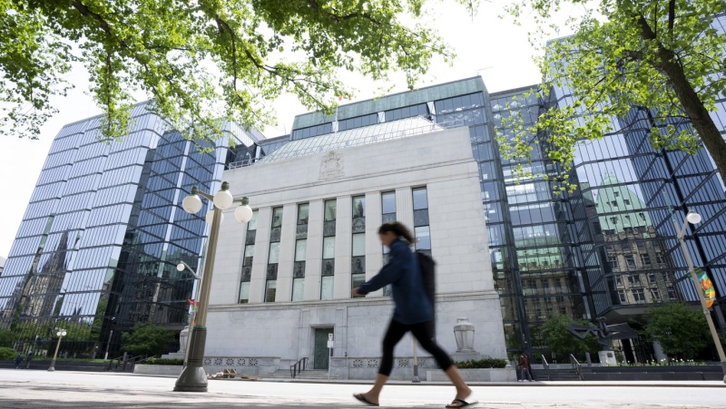 The Bank of Canada is set to announce its interest rate decision this morning as speculation about another rate hike heats up. A woman walks past the Bank of Canada headquarters, Wednesday, June 1, 2022 in Ottawa. THE CANADIAN PRESS/Adrian Wyld
