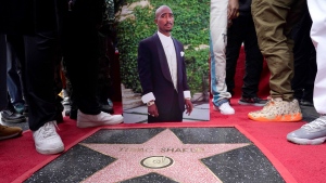 An image of the late rapper/actor Tupac Shakur appears near his new star on the Hollywood Walk of Fame during a posthumous ceremony in his honor on Wednesday, June 7, 2023, in Los Angeles. (AP Photo/Chris Pizzello)