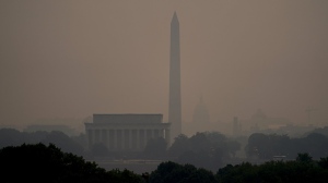 Haze blankets over monuments on the National Mall in Washington, Wednesday, June 7, 2023, as seen from Arlington, Va. Smoke from Canadian wildfires is pouring into the U.S. East Coast and Midwest and covering the capitals of both nations in an unhealthy haze. (AP Photo/Julio Cortez)
