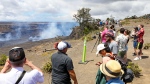 Visitors line the side of an overlook to view the Kilauea eruption in Hawaii on Wednesday, June 7, 2023. Hawaii tourism officials are urging tourists to be respectful when flocking to a national park on the Big Island to get a glimpse of the latest eruption of Kilauea. It's one of the world's most active volcanoes and began erupting after a three-month pause. (Kelsey Walling/Hawaii Tribune-Herald via AP)