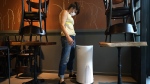 Restaurant owner Samantha DiStefano looks over an air purifier in New York, Tuesday, Sept. 29, 2020. The spread of smoke from wildfires across Canada in recent weeks has meant an uptick in demand for air quality products. THE CANADIAN PRESS/AP-Kathy Willens