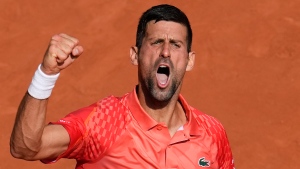 Serbia's Novak Djokovic clenches his fist after scoring a point against Spain's Carlos Alcaraz during their semifinal match of the French Open tennis tournament at the Roland Garros stadium in Paris, Friday, June 9, 2023. (AP Photo/Christophe Ena)