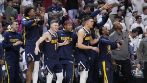 The Denver Nuggets celebrate during the second half of Game 4 of the basketball NBA Finals against the Miami Heat, Friday, June 9, 2023, in Miami. The Nuggets defeated the Heat 108-95. (AP Photo/Wilfredo Lee)