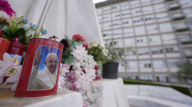 candle with the image of Pope Francis