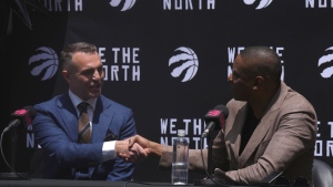 Toronto Raptors new head coach Darko Rajakovic shakes hands with team president Masai Ujuri at a news conference in Toronto on Tuesday, June 13, 2023. THE CANADIAN PRESS/Chris Young