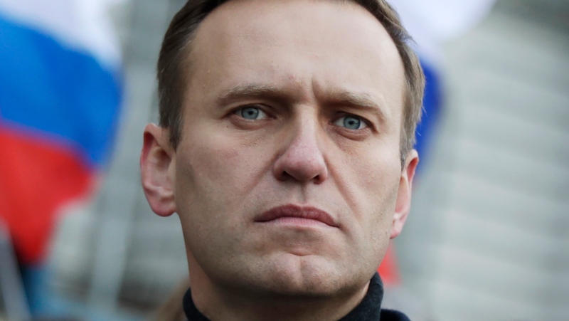 FILE - Russian opposition activist Alexei Navalny takes part in a march in memory of opposition leader Boris Nemtsov in Moscow, Russia, on Feb. 29, 2020. (AP Photo/Pavel Golovkin, File)