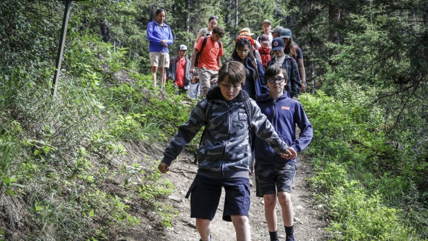 Brothers Nathan Zack, left, and Conner Zack lead a hike as they attend the Rockies Journey camp run by Howl in Kananaskis on Monday, July 3, 2023. Howl is a non-profit organization offering unique learning experiences across Canada for youth who don’t know what comes next in life. THE CANADIAN PRESS/Jeff McIntosh