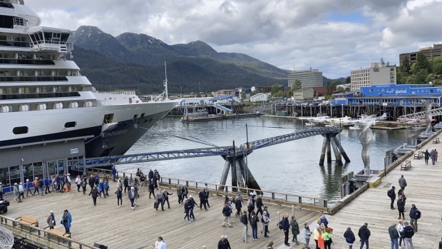 Passengers disembark from a cruise ship that has docked on June 12, 2023, in downtown Juneau, Alaska. As the Mendenhall Glacier continues to recede, tourists are flooding into Juneau. A record number of cruise ship passengers are expected this year in the city of about 30,000 people. (AP Photo/Becky Bohrer)