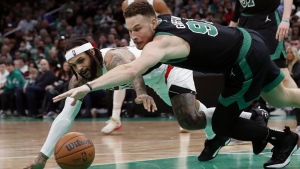 Boston Celtics' Blake Griffin (91) battles Toronto Raptors' Gary Trent Jr. for the ball during the second half of an NBA basketball game, Friday, April 7, 2023, in Boston. THE CANADIAN PRESS/AP-Michael Dwyer