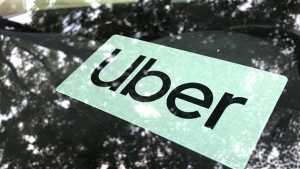 FILE- An Uber sign is displayed inside a car in Palatine, Ill., Monday, May 22, 2023. The Ride-hailing company Uber announced Aug. 24, 2023, that it will raise the minimum age for drivers who will transport others to 25. (AP Photo/Nam Y. Huh,File)
