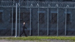 An correctional officer walks inside the Collins Bay Institution in Kingston, Ont., on Tuesday May 10, 2016.  THE CANADIAN PRESS/Lars Hagberg