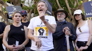 Rhea Seehorn, from left, Matt Jones, Bryan Cranston, writer Peter Gould and Betsy Brandt, from the acting and writing team of "Breaking Bad," speak on a picket line outside Sony Pictures studios on Tuesday, Aug. 29, 2023, in Culver City, Calif. The film and television industries remain paralyzed by Hollywood's dual actors and screenwriters strikes. (AP Photo/Chris Pizzello)